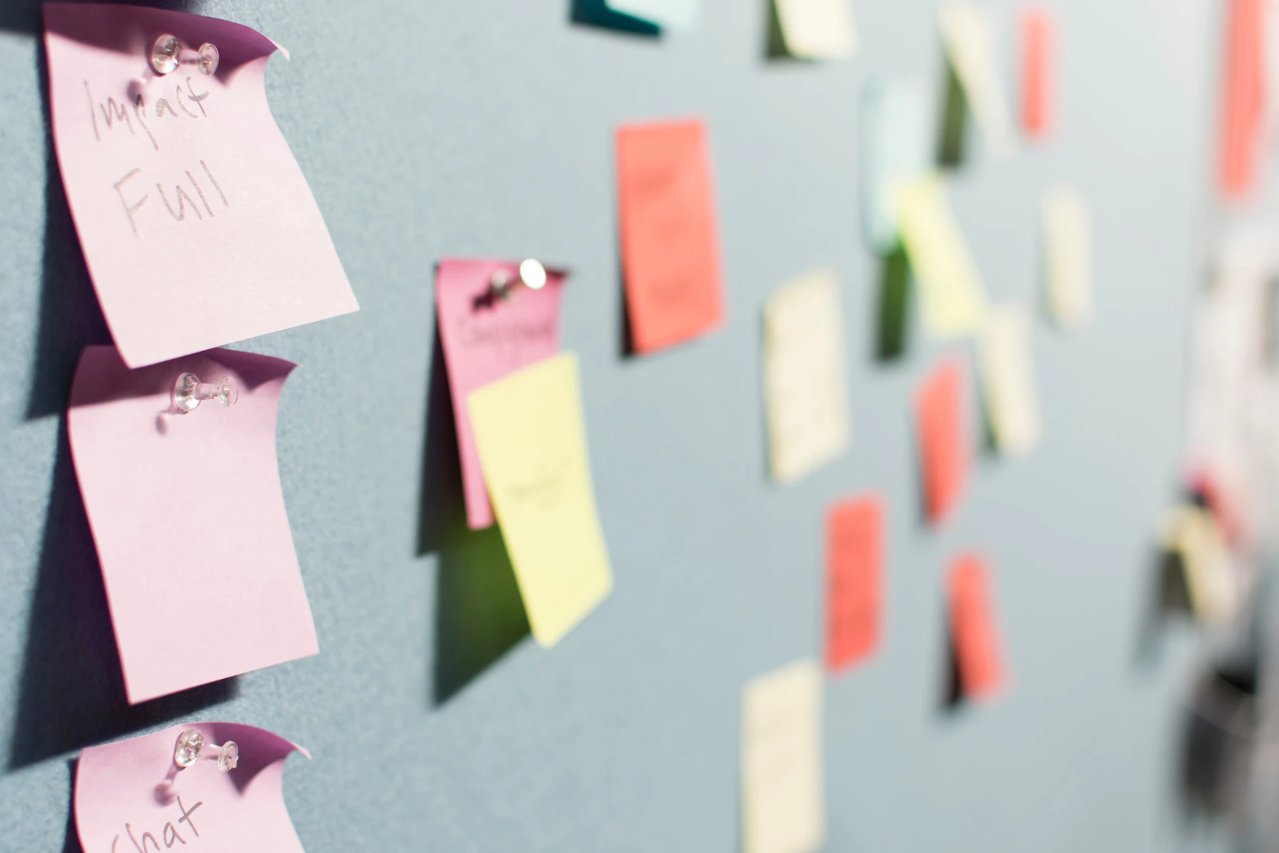 Colourful notes pinned to a board